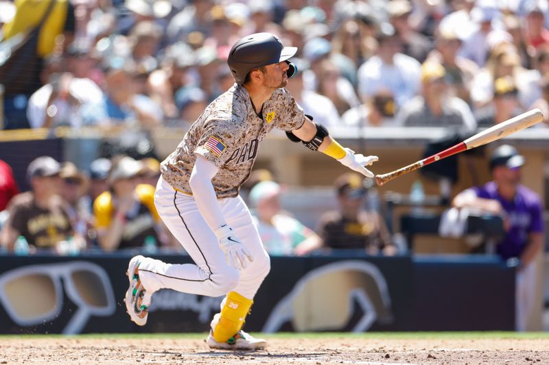 Aug 4, 2024; San Diego, California, USA; San Diego Padres catcher Kyle Higashioka (20) throws his bat after hitting a one run home run during the fifth inning against the Colorado Rockies at Petco Park. Mandatory Credit: David Frerker-USA TODAY Sports