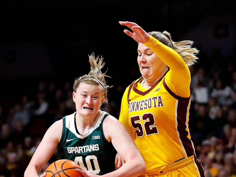 Jan 20, 2024; Minneapolis, Minnesota, USA; Michigan State Spartans guard Julia Ayrault (40) works around Minnesota Golden Gophers center Sophie Hart (52) during the second half at Williams Arena. Mandatory Credit: Matt Krohn-USA TODAY Sports