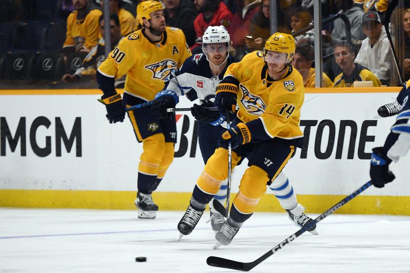 Nov 26, 2023; Nashville, Tennessee, USA; Nashville Predators left wing Gustav Nyquist (14) passes the puck in the offensive zone during the first period against the Winnipeg Jets at Bridgestone Arena. Mandatory Credit: Christopher Hanewinckel-USA TODAY Sports