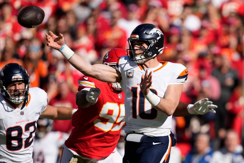 Denver Broncos quarterback Bo Nix throws during the first half of an NFL football game against the Kansas City Chiefs Sunday, Nov. 10, 2024, in Kansas City, Mo. (AP Photo/Ed Zurga)