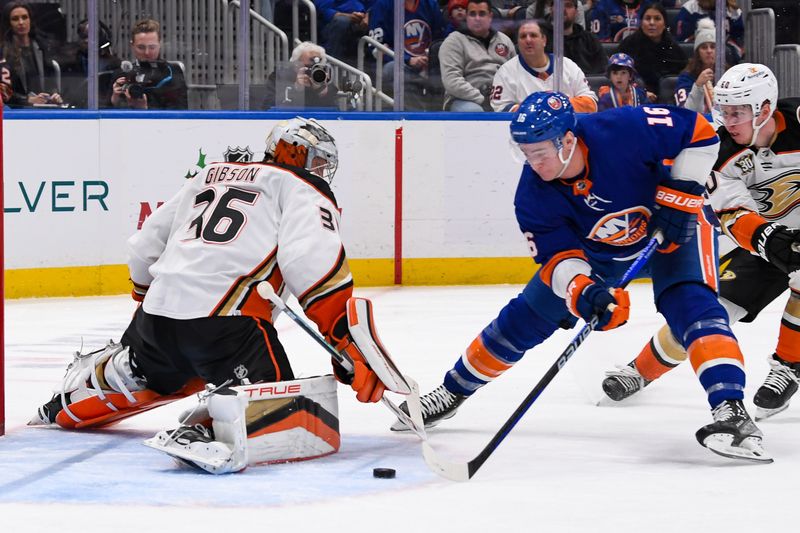 Dec 13, 2023; Elmont, New York, USA; Anaheim Ducks goaltender John Gibson (36) makes a save on New York Islanders right wing Julien Gauthier (16) during the second period at UBS Arena. Mandatory Credit: Dennis Schneidler-USA TODAY Sports