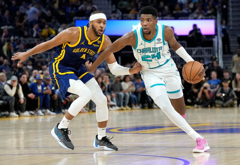 SAN FRANCISCO, CALIFORNIA - FEBRUARY 23: Brandon Miller #24 of the Charlotte Hornets dribbling the ball looks to drive to the basket on Moses Moody #4 of the Golden State Warriors during the fourth quarter of an NBA basketball game at Chase Center on February 23, 2024 in San Francisco, California. NOTE TO USER: User expressly acknowledges and agrees that, by downloading and or using this photograph, User is consenting to the terms and conditions of the Getty Images License Agreement. (Photo by Thearon W. Henderson/Getty Images)