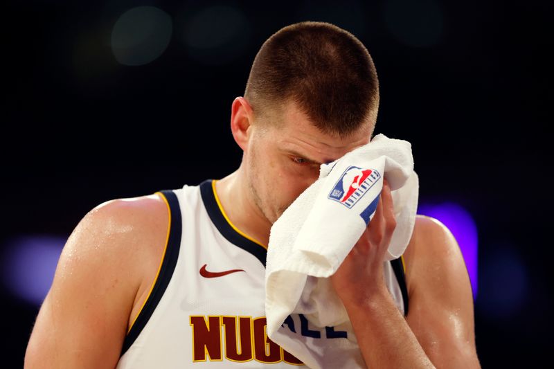 NEW YORK, NEW YORK - JANUARY 25: Nikola Jokic #15 of the Denver Nuggets reacts after an injury to his eye during the first half against the New York Knicks at Madison Square Garden on January 25, 2024 in New York City. NOTE TO USER: User expressly acknowledges and agrees that, by downloading and/or using this Photograph, user is consenting to the terms and conditions of the Getty Images License Agreement. (Photo by Sarah Stier/Getty Images)