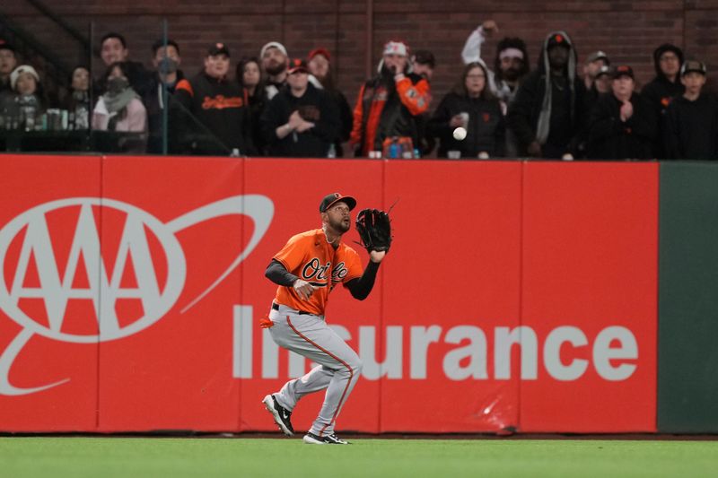 Jun 3, 2023; San Francisco, California, USA;  Baltimore Orioles center fielder Aaron Hicks (34) catches a fly ball against the San Francisco Giants during the sixth inning at Oracle Park. Mandatory Credit: Darren Yamashita-USA TODAY Sports