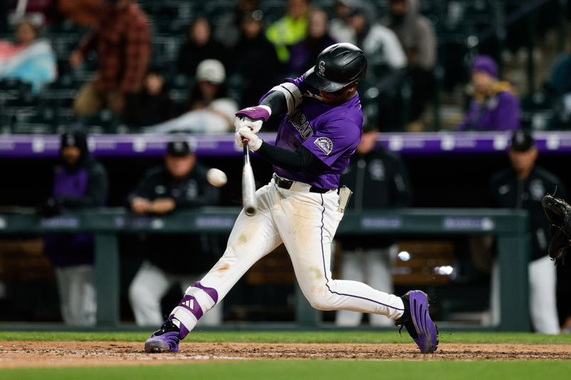 Apr 28, 2025; Denver, Colorado, USA; Colorado Rockies second baseman Adael Amador (1) hits a single in the ninth inning against the Atlanta Braves at Coors Field. Mandatory Credit: Isaiah J. Downing-Imagn Images