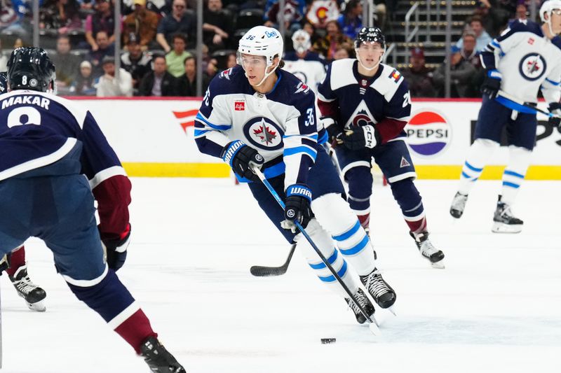 Dec 7, 2023; Denver, Colorado, USA; Winnipeg Jets center Morgan Barron (36) controls the puck in the first period against the Colorado Avalanche at Ball Arena. Mandatory Credit: Ron Chenoy-USA TODAY Sports