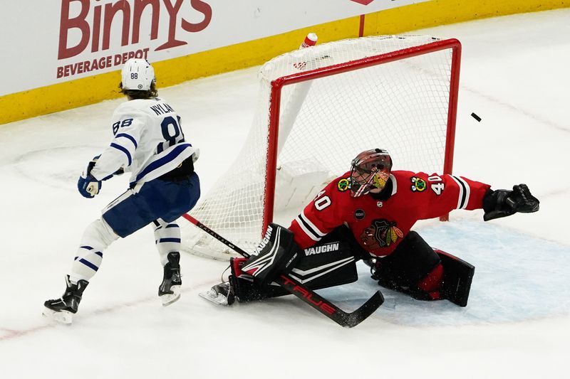 Nov 24, 2023; Chicago, Illinois, USA; Chicago Blackhawks goaltender Arvid Soderblom (40) makes a save on Toronto Maple Leafs right wing William Nylander (88) during an overtime period at United Center. Mandatory Credit: David Banks-USA TODAY Sports