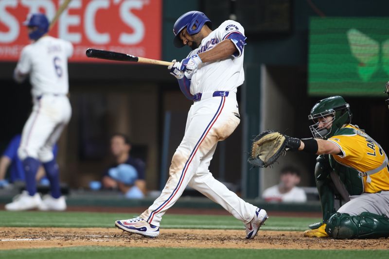 Apr 29, 2025; Arlington, Texas, USA; Texas Rangers shortstop Josh Smith (8) singles in a run during the sixth inning against the Oakland Athletics at Globe Life Field. Mandatory Credit: Tim Heitman-Imagn Images