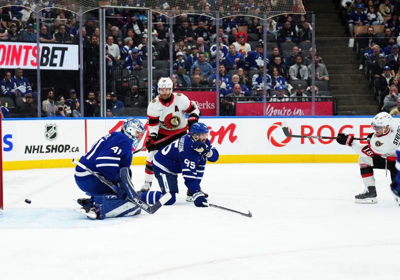 Nov 12, 2024; Toronto, Ontario, CAN; Ottawa Senators center Tim Stützle (18) scores against Toronto Maple Leafs goalie Anthony Stolarz (41) during the second period at Scotiabank Arena. Mandatory Credit: Nick Turchiaro-Imagn Images