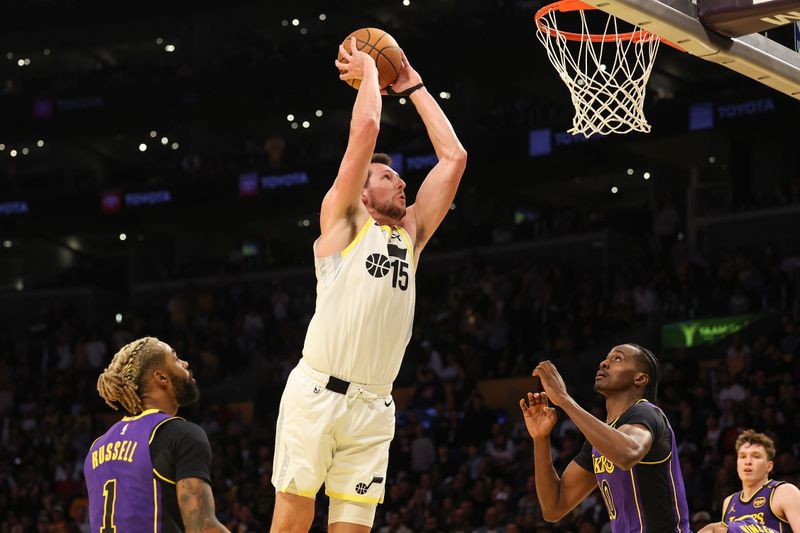 LOS ANGELES, CALIFORNIA - NOVEMBER 19: Drew Eubanks #15 of the Utah Jazz dunks as D'Angelo Russell #1 and Christian Koloko #10 of the Los Angeles Lakers look on during the third quarter of the Emirates NBA Cup at Crypto.com Arena on November 19, 2024 in Los Angeles, California. NOTE TO USER: User expressly acknowledges and agrees that, by downloading and or using this photograph, User is consenting to the terms and conditions of the Getty Images License Agreement.  (Photo by Harry How/Getty Images)