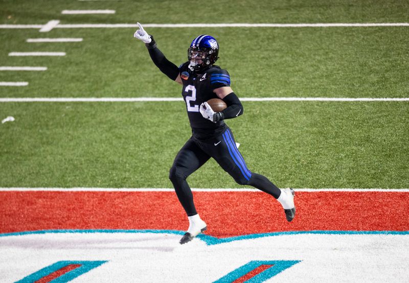 Dec 17, 2022; Albuquerque, New Mexico, USA; Brigham Young Cougars linebacker Ben Bywater (2) celebrates as he runs back an interception for a touchdown against the Southern Methodist Mustangs at University Stadium (Albuquerque). Mandatory Credit: Ivan Pierre Aguirre-USA TODAY Sports