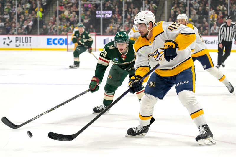 Jan 25, 2024; Saint Paul, Minnesota, USA; Nashville Predators defenseman Alexandre Carrier (45) makes a pass as Minnesota Wild forward Marco Rossi (23) defends during the first period at Xcel Energy Center. Mandatory Credit: Nick Wosika-USA TODAY Sports