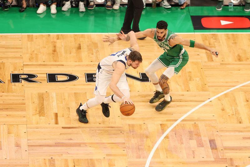 BOSTON, MA - JUNE 17: Jayson Tatum #0 of the Boston Celtics plays defense during the game  against Luka Doncic #77 of the Dallas Mavericks during Game 5 of the 2024 NBA Finals on June 17, 2024 at the TD Garden in Boston, Massachusetts. NOTE TO USER: User expressly acknowledges and agrees that, by downloading and or using this photograph, User is consenting to the terms and conditions of the Getty Images License Agreement. Mandatory Copyright Notice: Copyright 2024 NBAE  (Photo by Stephen Gosling/NBAE via Getty Images)