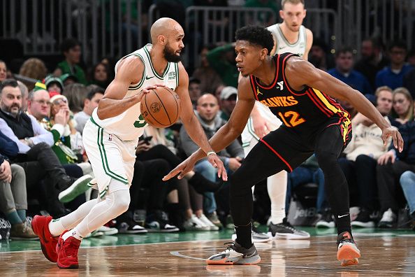 BOSTON, MASSACHUSETTS - NOVEMBER 26: Derrick White #9 of the Boston Celtics drives to the basket against De'Andre Hunter #12 of the Atlanta Hawks during the second quarter at the TD Garden on November 26, 2023 in Boston, Massachusetts. NOTE TO USER: User expressly acknowledges and agrees that, by downloading and or using this photograph, User is consenting to the terms and conditions of the Getty Images License Agreement. (Photo by Brian Fluharty/Getty Images)