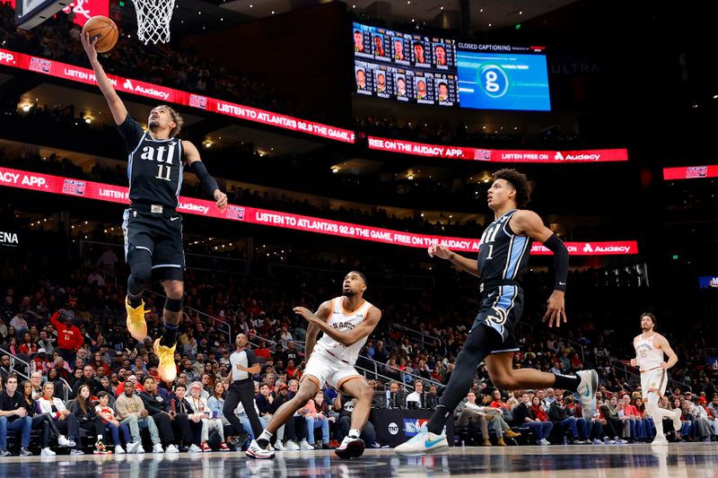 ATLANTA, GEORGIA - JANUARY 15: Trae Young #11 of the Atlanta Hawks shoots over Blake Wesley #14 of the San Antonio Spurs during the first half at State Farm Arena on January 15, 2024 in Atlanta, Georgia. NOTE TO USER: User expressly acknowledges and agrees that, by downloading and or using this photograph, User is consenting to the terms and conditions of the Getty Images License Agreement. (Photo by Alex Slitz/Getty Images)