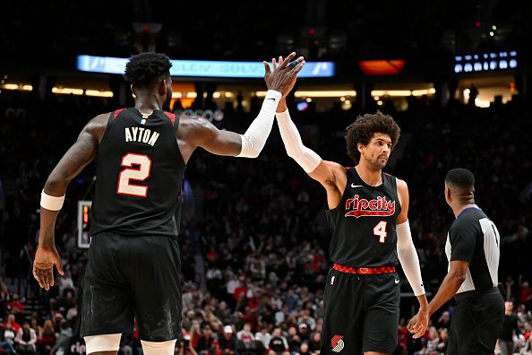 PORTLAND, OREGON - DECEMBER 21: Matisse Thybulle #4 of the Portland Trail Blazers and Deandre Ayton #2 high-five during the fourth quarter of the game against the Washington Wizards at the Moda Center on December 21, 2023 in Portland, Oregon. The Washington Wizards won 118-117. NOTE TO USER: User expressly acknowledges and agrees that, by downloading and or using this photograph, User is consenting to the terms and conditions of the Getty Images License Agreement. (Photo by Alika Jenner/Getty Images)