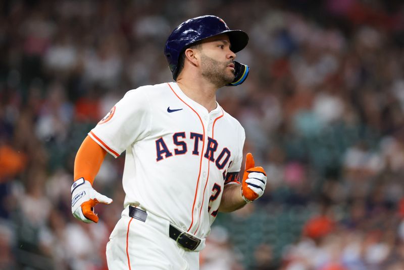 May 27, 2025; Houston, Texas, USA; Houston Astros designated hitter Jose Altuve (27) hits a single against the Athletics in the first inning  at Daikin Park. Mandatory Credit: Thomas Shea-Imagn Images