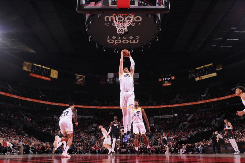 PORTLAND, OR - DECEMBER 6: Walker Kessler #24 of the Utah Jazz rebounds the ball during the game against the Portland Trail Blazers on December 6, 2024 at the Moda Center Arena in Portland, Oregon. NOTE TO USER: User expressly acknowledges and agrees that, by downloading and or using this photograph, user is consenting to the terms and conditions of the Getty Images License Agreement. Mandatory Copyright Notice: Copyright 2024 NBAE (Photo by Cameron Browne/NBAE via Getty Images)