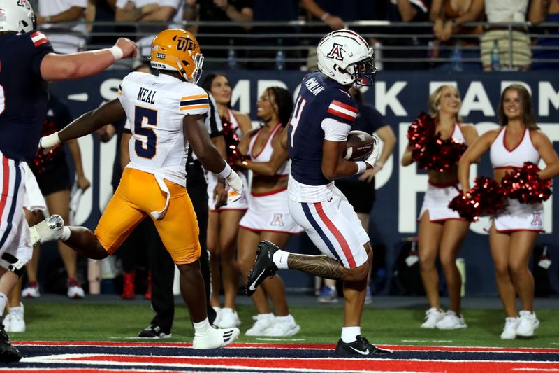 Sep 16, 2023; Tucson, Arizona, USA; Arizona Wildcats wide receiver Tetairoa McMillan (4) makes a touchdown catch against UTEP Miners linebacker James Neal (5) during the first half at Arizona Stadium. Mandatory Credit: Zachary BonDurant-USA TODAY Sports