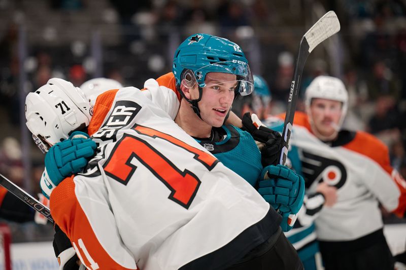 Nov 7, 2023; San Jose, California, USA; San Jose Sharks center William Eklund (72) smiles as he grabs Philadelphia Flyers right wing Tyson Foerster (71) during the second period at SAP Center at San Jose. Mandatory Credit: Robert Edwards-USA TODAY Sports