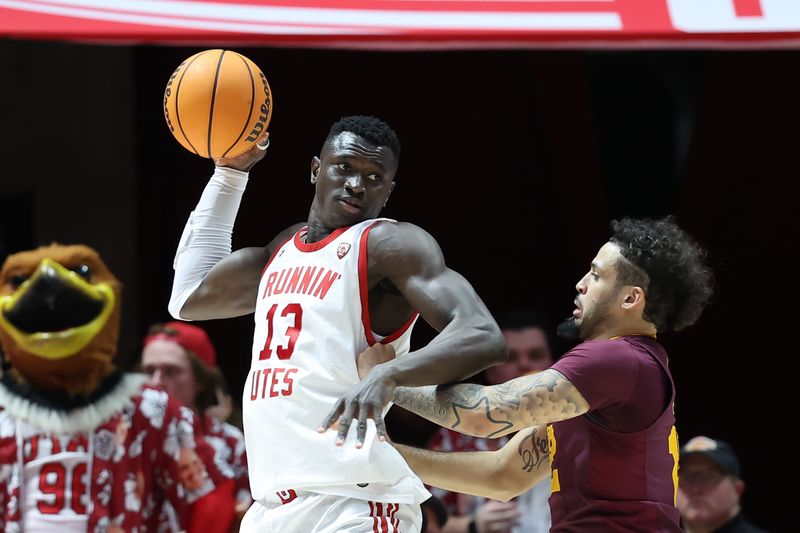 Feb 10, 2024; Salt Lake City, Utah, USA; Utah Utes center Keba Keita (13) holds the ball away from Arizona State Sun Devils guard Jose Perez (12) during the first half at Jon M. Huntsman Center. Mandatory Credit: Rob Gray-USA TODAY Sports