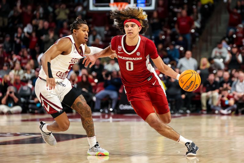 Feb 4, 2023; Columbia, South Carolina, USA; Arkansas Razorbacks guard Anthony Black (0) drives around South Carolina Gamecocks guard Meechie Johnson (5) in the second half at Colonial Life Arena. Mandatory Credit: Jeff Blake-USA TODAY Sports