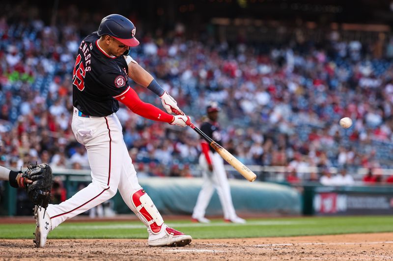 Apr 20, 2024; Washington, District of Columbia, USA; Washington Nationals first base Joey Meneses (45) hits the game winning RBI single against the Houston Astros during the tenth inning at Nationals Park. Mandatory Credit: Scott Taetsch-USA TODAY Sports