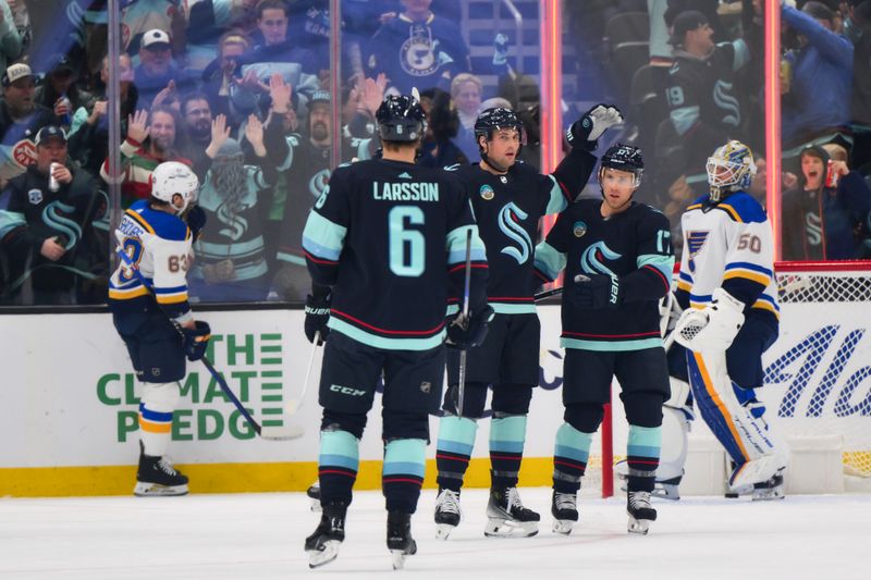 Jan 26, 2024; Seattle, Washington, USA; The Seattle Kraken celebrates after defenseman Brian Dumoulin (8) scored a goal against the St. Louis Blues during the first period at Climate Pledge Arena. Mandatory Credit: Steven Bisig-USA TODAY Sports