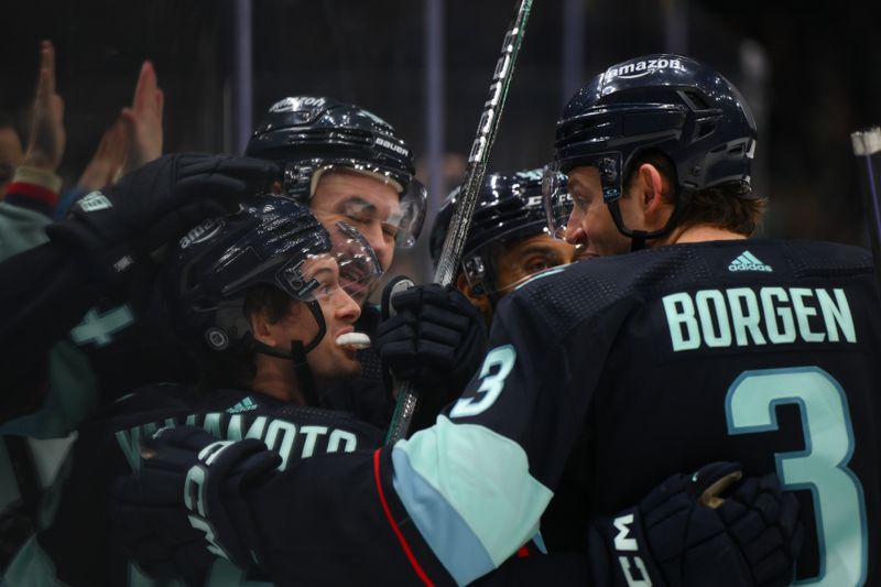 Dec 12, 2023; Seattle, Washington, USA; The Seattle Kraken celebrate after right wing Kailer Yamamoto (56) scored a goal against the Florida Panthers during the second period at Climate Pledge Arena. Mandatory Credit: Steven Bisig-USA TODAY Sports