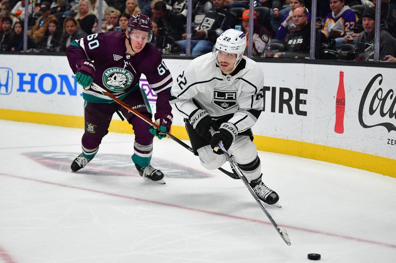 Nov 24, 2023; Anaheim, California, USA; Los Angeles Kings left wing Kevin Fiala (22) moves the puck ahead of Anaheim Ducks defenseman Jackson LaCombe (60) during the third period at Honda Center. Mandatory Credit: Gary A. Vasquez-USA TODAY Sports