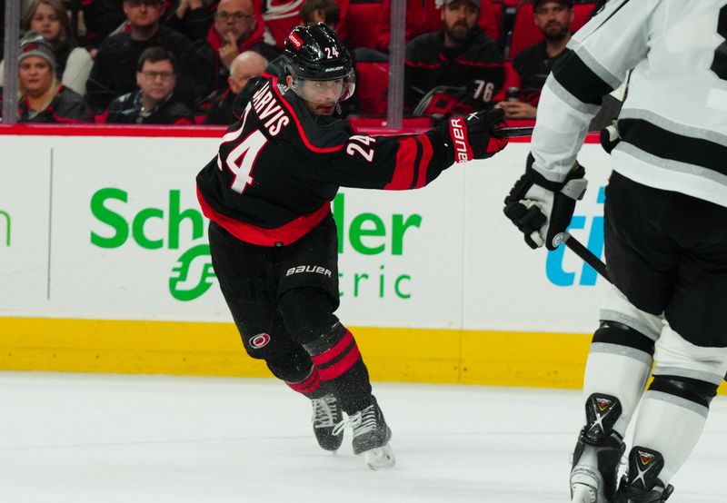 Jan 15, 2024; Raleigh, North Carolina, USA;  Carolina Hurricanes center Seth Jarvis (24) takes a shot against the Los Angeles Kings during the third period at PNC Arena. Mandatory Credit: James Guillory-USA TODAY Sports