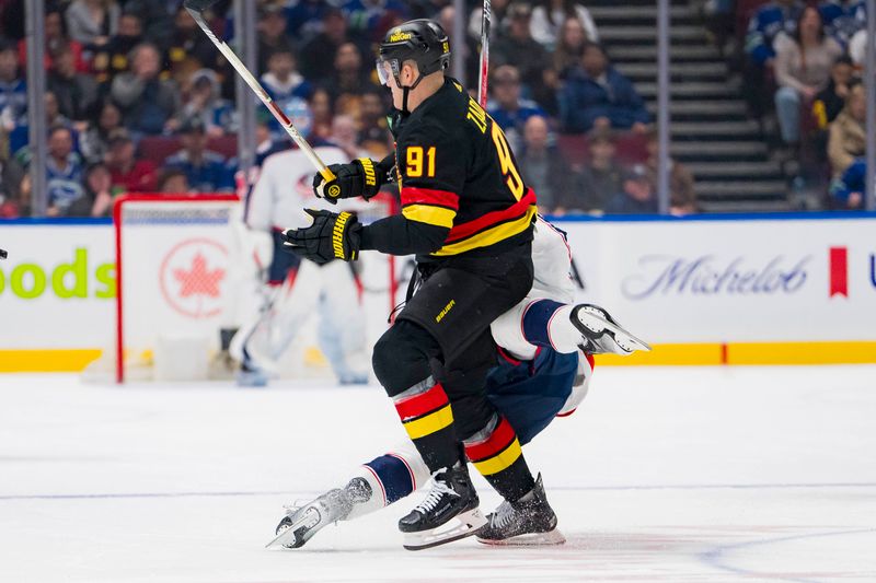 Jan 27, 2024; Vancouver, British Columbia, CAN; Vancouver Canucks defenseman Nikita Zadorov (91) checks Columbus Blue Jackets forward Jack Roslovic (96) in the first period at Rogers Arena. Mandatory Credit: Bob Frid-USA TODAY Sports