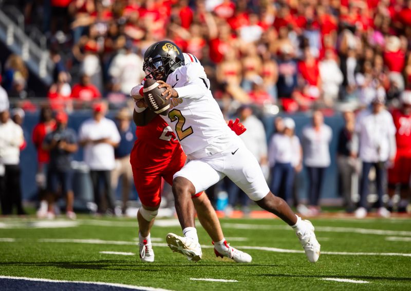 Oct 19, 2024; Tucson, Arizona, USA; Colorado Buffalos quarterback Shedeur Sanders (2) runs for a touchdown against the Arizona Wildcats in the first half at Arizona Stadium. Mandatory Credit: Mark J. Rebilas-Imagn Images