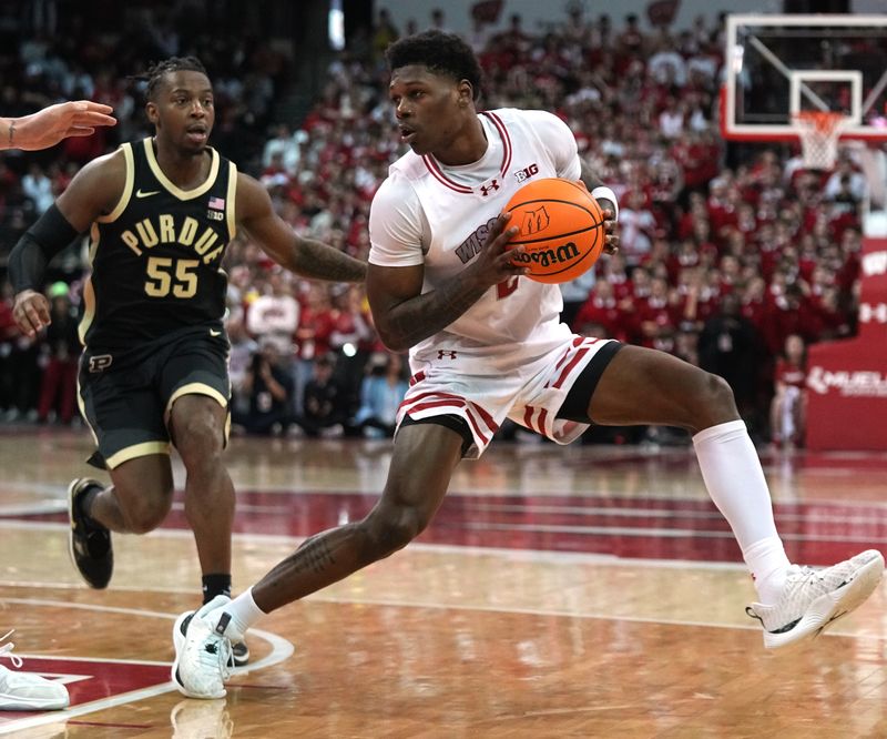 Feb 4, 2024; Madison, Wisconsin, USA; Wisconsin guard AJ Storr (2) makes a move on Purdue guard Lance Jones (55) during the second half at Kohl Center. Mandatory Credit: Mark Hoffman-USA TODAY Sports