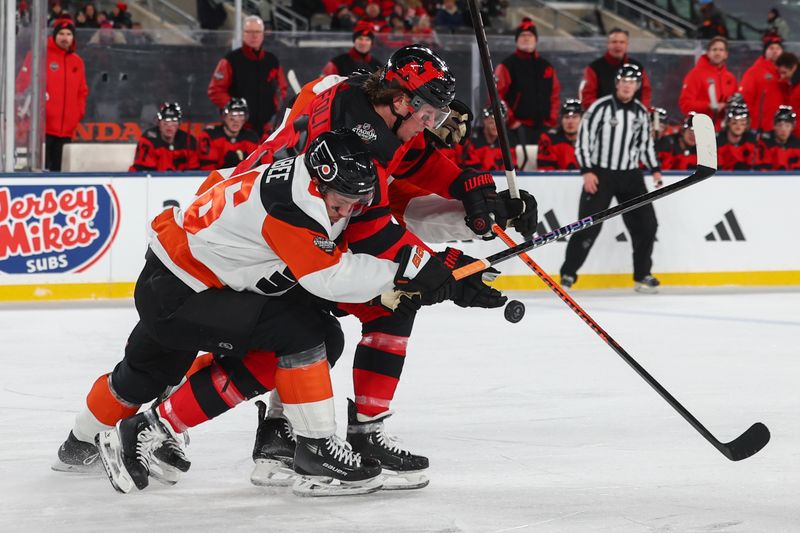 Feb 17, 2024; East Rutherford, New Jersey, USA; New Jersey Devils right wing Tyler Toffoli (73) and Philadelphia Flyers left wing Joel Farabee (86) battle for the puck during the third period in a Stadium Series ice hockey game at MetLife Stadium. Mandatory Credit: Ed Mulholland-USA TODAY Sports