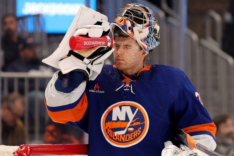 Nov 5, 2024; Elmont, New York, USA; New York Islanders goaltender Ilya Sorokin (30) sprays water on his face during a time out during the first period against the Pittsburgh Penguins at UBS Arena. Mandatory Credit: Brad Penner-Imagn Images