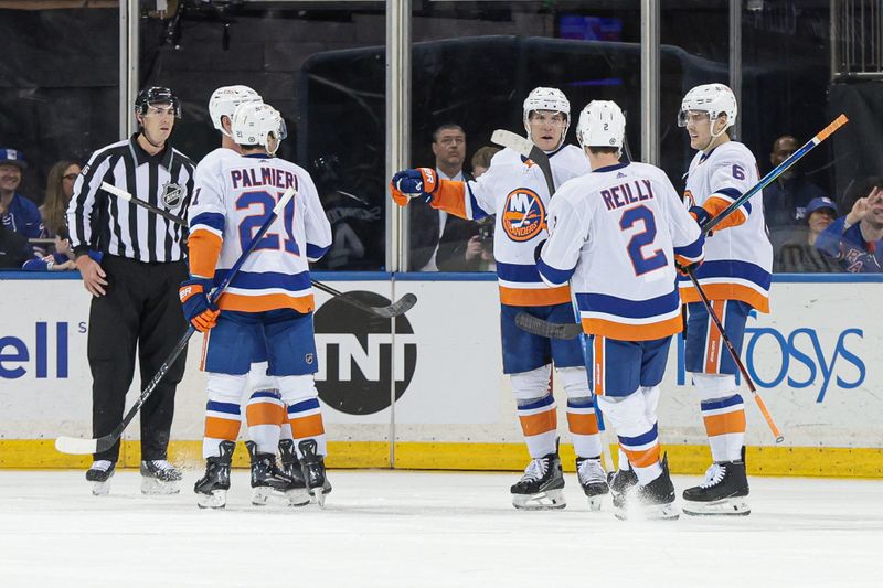 Mar 17, 2024; New York, New York, USA; New York Islanders center Bo Horvat (14) celebrates his goal with teammates during the second period against the New York Rangers at Madison Square Garden. Mandatory Credit: Vincent Carchietta-USA TODAY Sports