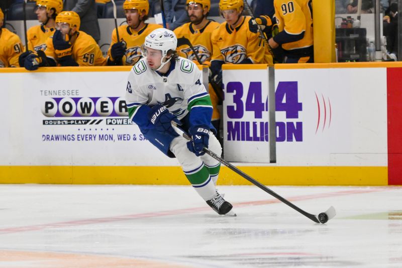 Oct 23, 2025; Nashville, Tennessee, USA;  Vancouver Canucks defenseman Quinn Hughes (43) skates with the puck against the Nashville Predators during the first period at Bridgestone Arena. Mandatory Credit: Steve Roberts-Imagn Images