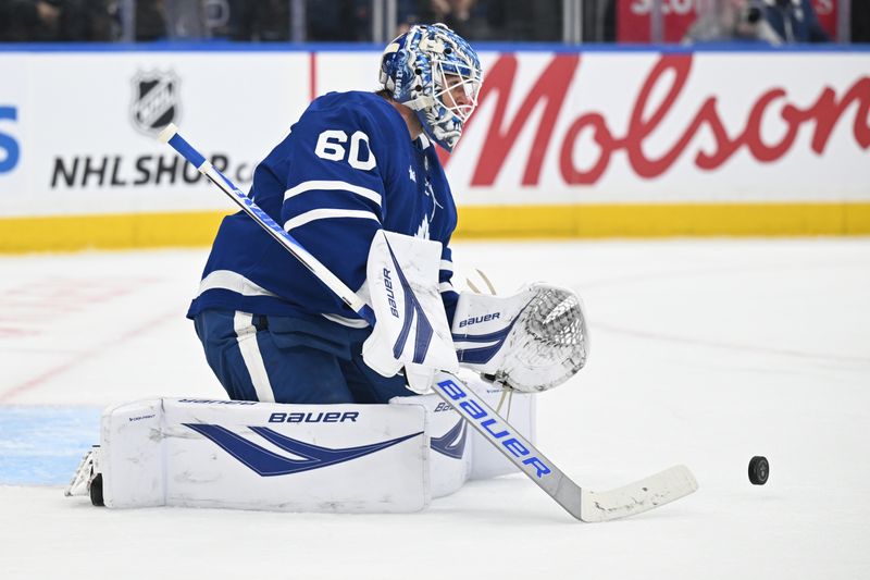 Dec 23, 2025; Toronto, Ontario, CAN;  Toronto Maple Leafs goalie Joseph Woll (60) stops a shot against the Pittsburgh Penguins in the second period at Scotiabank Arena. Mandatory Credit: Dan Hamilton-Imagn Images