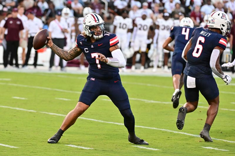 Sep 9, 2023; Starkville, Mississippi, USA; Arizona Wildcats quarterback Jayden de Laura (7) looks to pass against the Mississippi State Bulldogs during the first quarter at Davis Wade Stadium at Scott Field. Mandatory Credit: Matt Bush-USA TODAY Sports