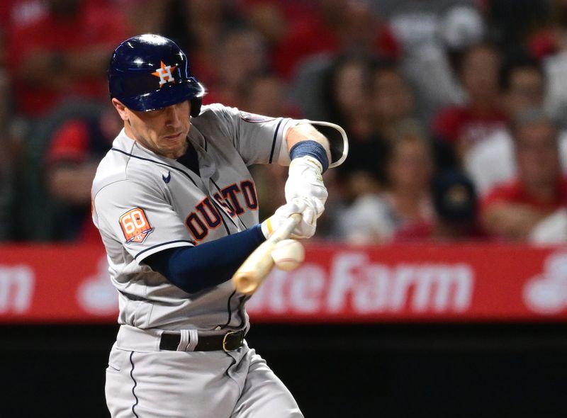Apr 7, 2022; Anaheim, California, USA; Houston Astros third baseman Alex Bregman (2) hits an RBI single in the third inning against the Los Angeles Angels at Angel Stadium. Mandatory Credit: Jayne Kamin-Oncea-USA TODAY Sports