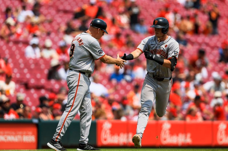 Aug 4, 2024; Cincinnati, Ohio, USA; San Francisco Giants shortstop Tyler Fitzgerald (49) shakes hands with third base coach Matt Williams (9) after hitting a two-run home run in the eighth inning against the Cincinnati Reds at Great American Ball Park. Mandatory Credit: Katie Stratman-USA TODAY Sports