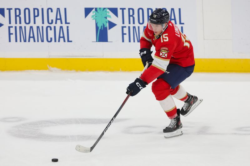 Dec 8, 2023; Sunrise, Florida, USA; Florida Panthers center Anton Lundell (15) moves the puck against the Pittsburgh Penguins during the third period at Amerant Bank Arena. Mandatory Credit: Sam Navarro-USA TODAY Sports