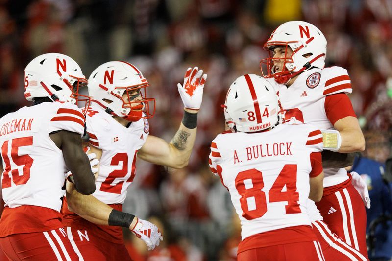 Nov 18, 2023; Madison, Wisconsin, USA;  Nebraska Cornhuskers quarterback Chubba Purdy (12) celebrates after scoring a touchdown during the first quarter against the Wisconsin Badgers at Camp Randall Stadium. Mandatory Credit: Jeff Hanisch-USA TODAY Sports