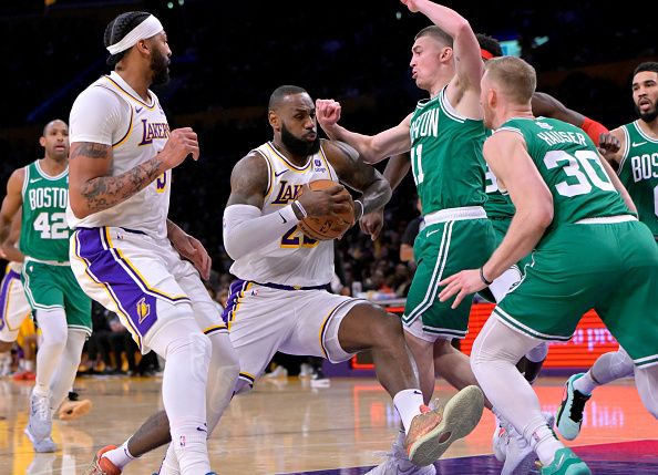 LOS ANGELES, CALIFORNIA - DECEMBER 25: LeBron James #23 of the Los Angeles Lakers drives against the Payton Pritchard #11 and Sam Hauser #30 of the Boston Celtics at Crypto.com Arena on December 25, 2023 in Los Angeles, California. NOTE TO USER: User expressly acknowledges and agrees that, by downloading and or using this photograph, User is consenting to the terms and conditions of the Getty Images License Agreement.(Photo by Jayne Kamin-Oncea/Getty Images)