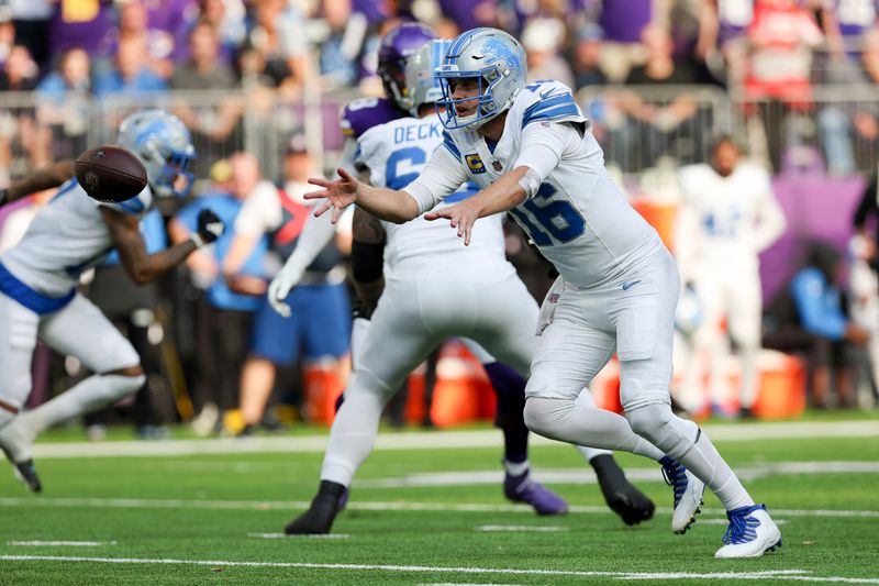 Detroit Lions quarterback Jared Goff (16) tosses the ball back during the second half of an NFL football game against the Minnesota Vikings, Sunday, Oct. 20, 2024 in Minneapolis. Detroit won 31-29. (AP Photo/Stacy Bengs)