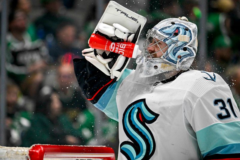 May 15, 2023; Dallas, Texas, USA; Seattle Kraken goaltender Philipp Grubauer (31) sprays his face with water during a stoppage in play during the second period against the Dallas Stars in game seven of the second round of the 2023 Stanley Cup Playoffs at the American Airlines Center. Mandatory Credit: Jerome Miron-USA TODAY Sports