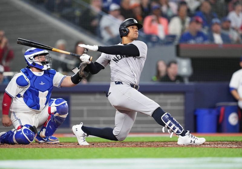 Apr 17, 2024; Toronto, Ontario, CAN; New York Yankees right fielder Juan Soto (22) hits a home run against the Toronto Blue Jays during the eighth inning at Rogers Centre. Mandatory Credit: Nick Turchiaro-USA TODAY Sports