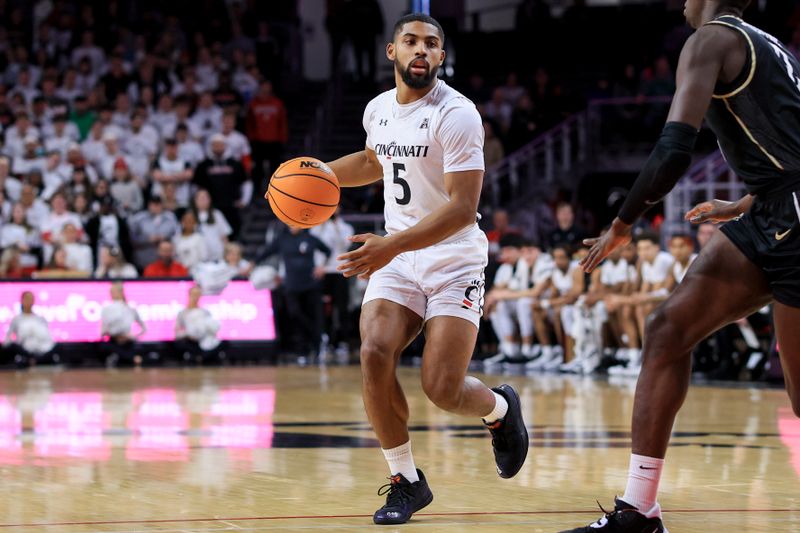 Feb 4, 2023; Cincinnati, Ohio, USA;  Cincinnati Bearcats guard David DeJulius (5) controls the ball against the UCF Knights in the first half at Fifth Third Arena. Mandatory Credit: Aaron Doster-USA TODAY Sports