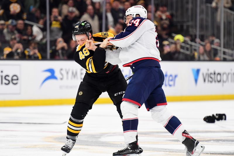 Nov 18, 2024; Boston, Massachusetts, USA;  Boston Bruins left wing Jeffrey Viel (48) fights with Columbus Blue Jackets right wing Mathieu Olivier (24) during the first period at TD Garden. Mandatory Credit: Bob DeChiara-Imagn Images